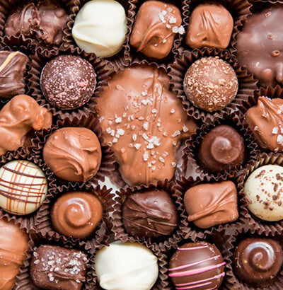 Assorted Veni’s chocolates in decorative packaging.
