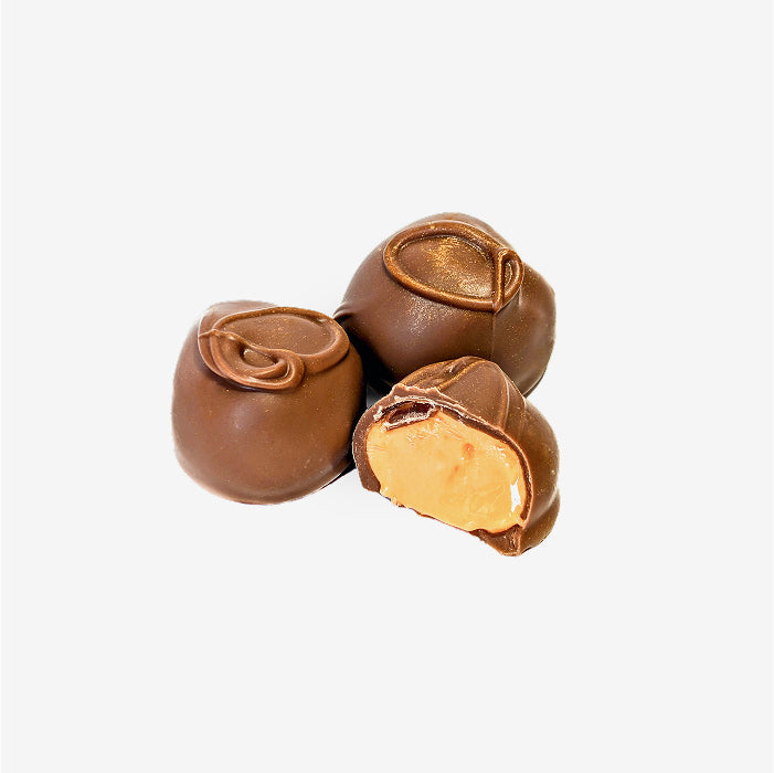 Three chocolate-covered treats on a white background