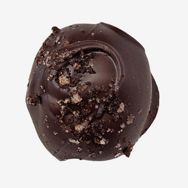 Chocolate truffle with cookie pieces on a white background