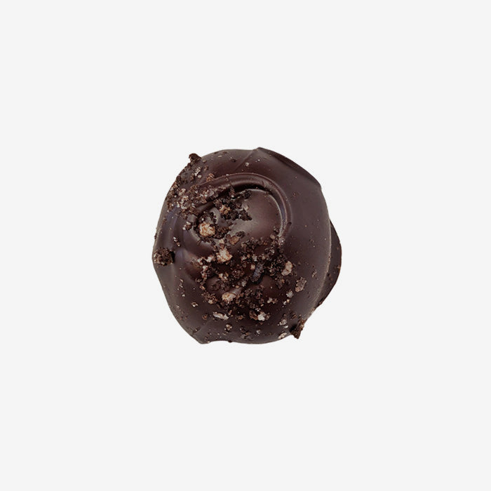Chocolate truffle with cookie pieces on a white background