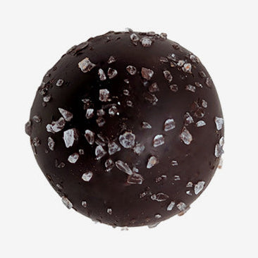 Chocolate truffle with silver碎片 on a white background