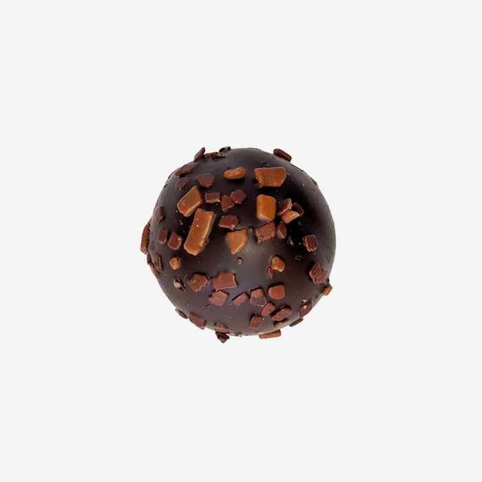 Chocolate truffle with chocolate pieces on a white background