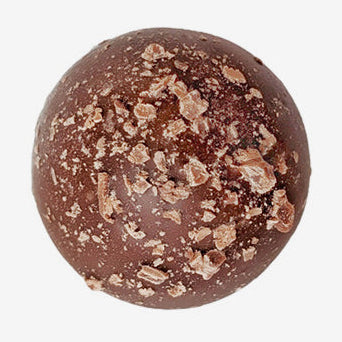 Chocolate truffle with a crumbly top on a white background