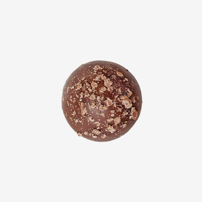 Chocolate truffle with a crumbly top on a white background