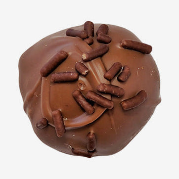 Chocolate truffle with sprinkles on a white background