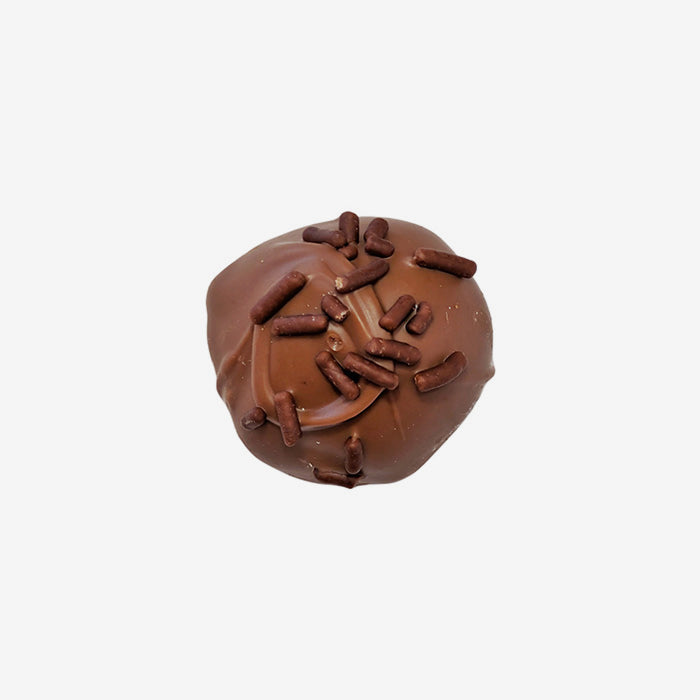 Chocolate truffle with sprinkles on a white background