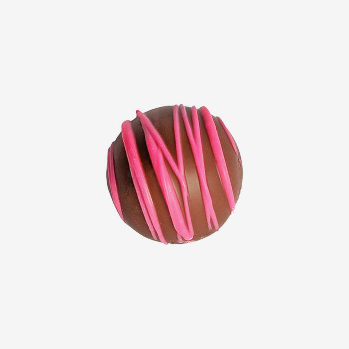 Chocolate truffle with pink drizzle on a white background