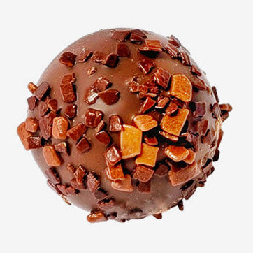 Chocolate truffle with toffee bits on a white background