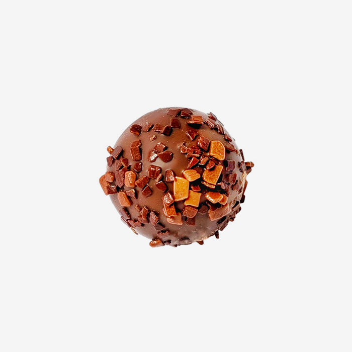 Chocolate truffle with toffee bits on a white background