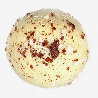 White chocolate truffle with chocolate chips on a white background