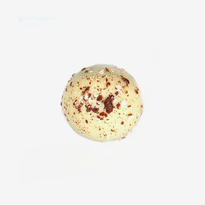 White chocolate truffle with chocolate chips on a white background