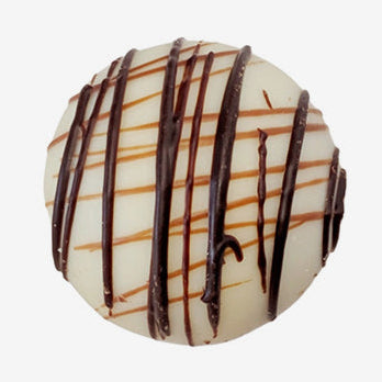 Chocolate truffle with drizzle on a white background