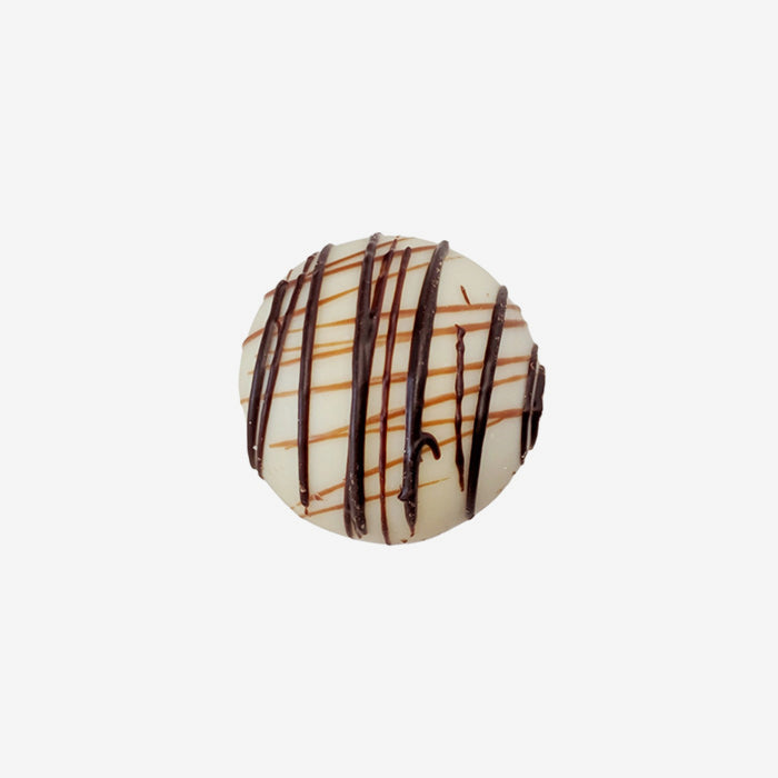 Chocolate truffle with drizzle on a white background