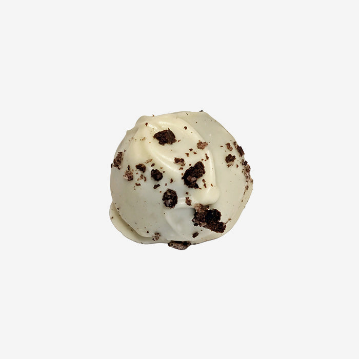 White chocolate truffle with cookie crumb pieces on a white background