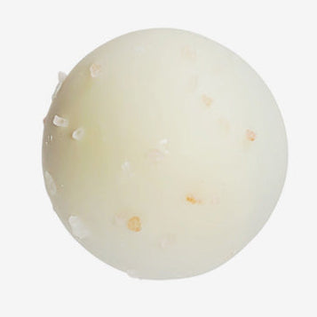 Round white object with specks on a light gray background