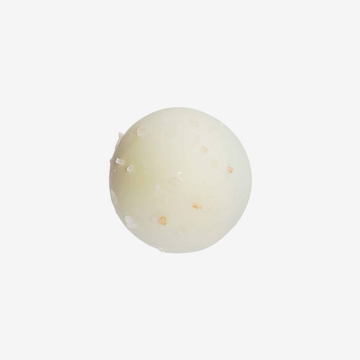 Round white object with specks on a light gray background