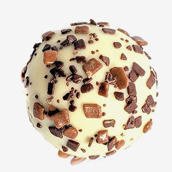 Chocolate truffle with chocolate chips on a light gray background