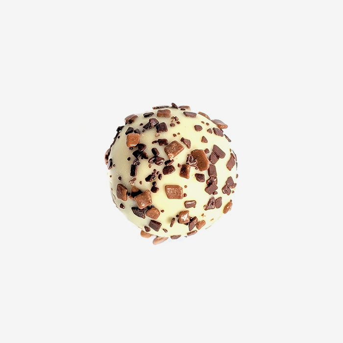 Chocolate truffle with chocolate chips on a light gray background