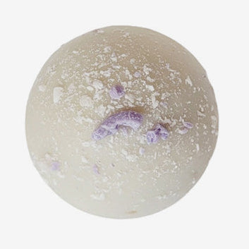 Round bath bomb with purple specks on a white background